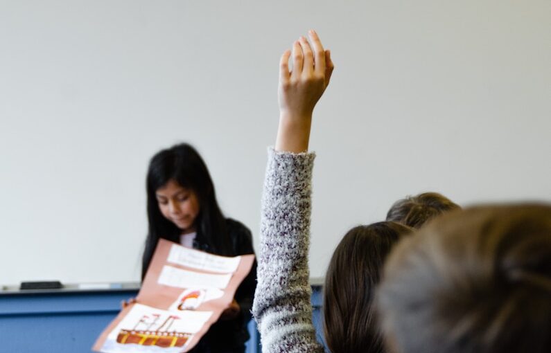 woman in gray sweater sitting beside woman in gray sweater